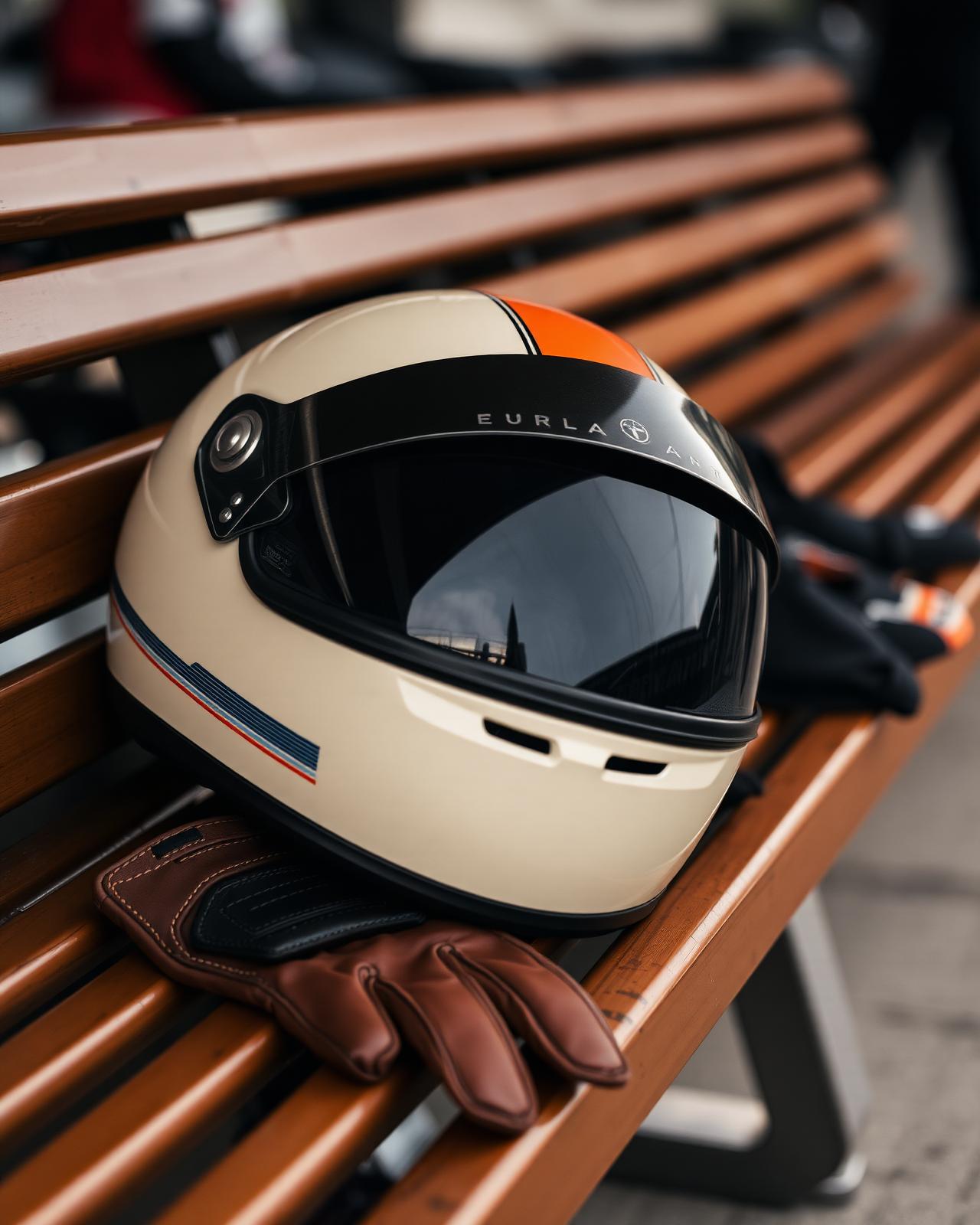 Racing helmet and gloves resting on a pit lane bench
